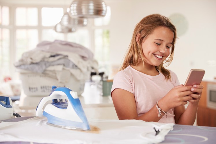 young-girl-using-distracted-by-phone-while-PLHTXRP.jpg