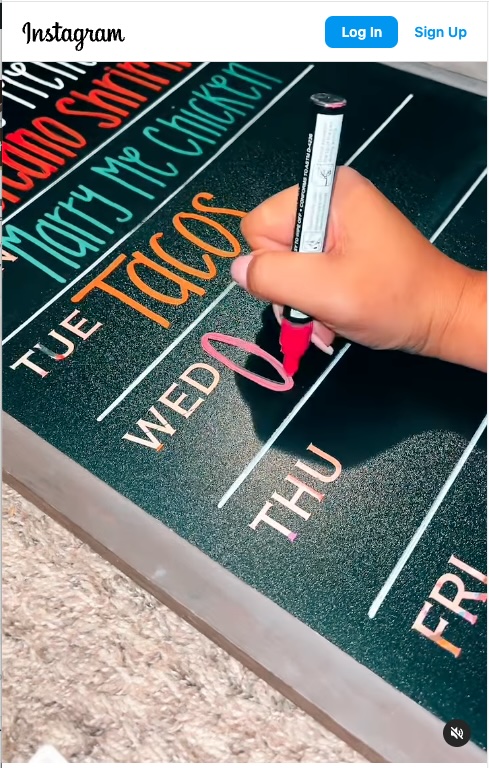 screen shot and link to an instagram video showing someone writing out a weekly meal plan with colored markers and a dry erase board.
